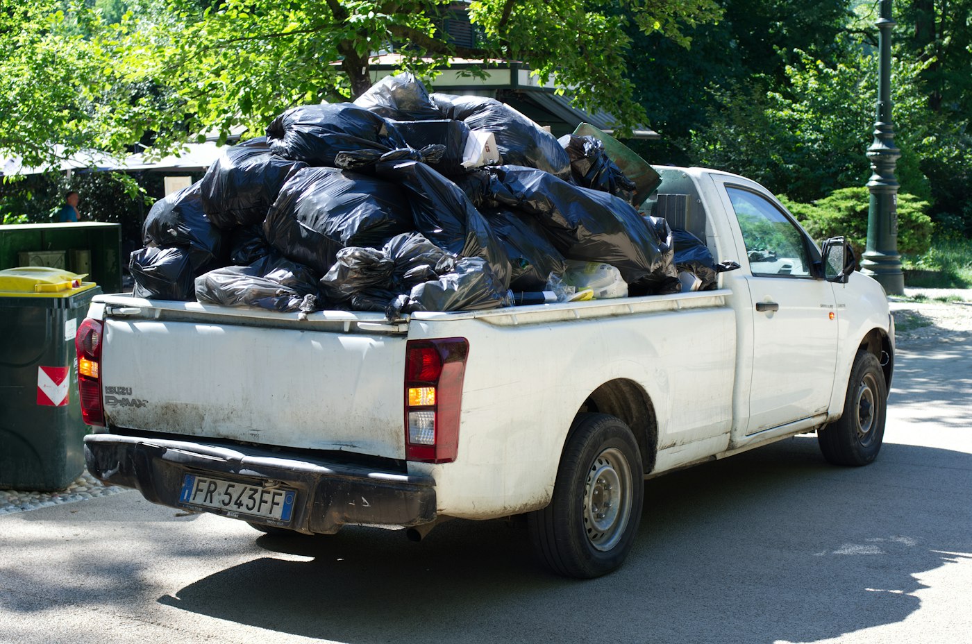 A pickup truck loaded with bags for removal