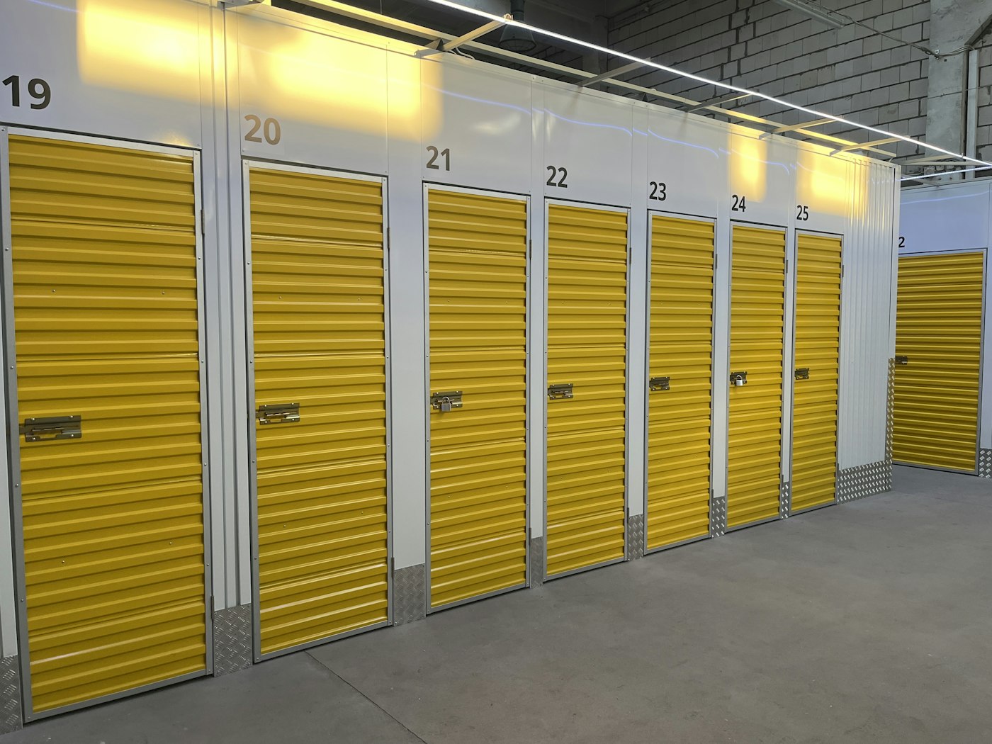 Rows of numbered storage units with yellow doors